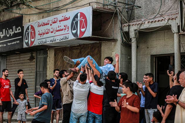 Gaza Families Celebrate Tawjihi Success Palestinian men and boys lift a young man above the crowd during celebrations of the Tawjihi results in Gaza City, northern Gaza Strip, on July 23, 2026. Families in displacement camps and neighborhoods across northern Gaza City held modest celebrations for students who passed the Tawjihi examinations amid war, blockade and severe humanitarian conditions. Gaza Gaza Strip Palestinian Territories Copyright: xFaizxQreqax
