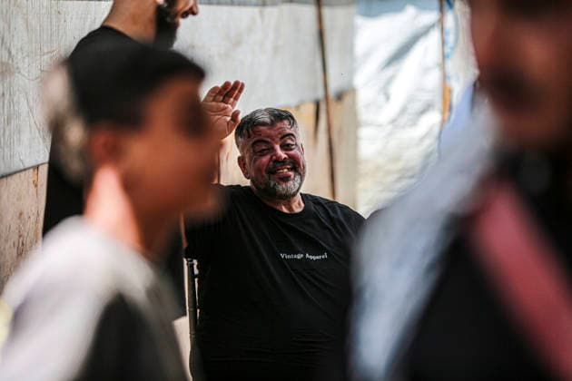 Gaza Families Celebrate Tawjihi Success A Palestinian man smiles and raises his hand while standing among residents during celebrations of the Tawjihi results in Gaza City, northern Gaza Strip, on July 23, 2026. Families in displacement camps and neighborhoods across northern Gaza City held modest celebrations for students who passed the Tawjihi examinations amid war, blockade and severe humanitarian conditions. Gaza Gaza Strip Palestinian Territories Copyright: xFaizxQreqax