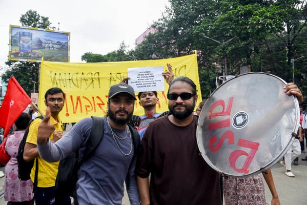 Kolkata Rally Supports CJP Protest Demonstrators pose with a drum in front of a yellow protest banner in Kolkata, India, on July 24, 2026. The rally was held in solidarity with the Cockroach Janta Party s ongoing protest at New Delhi s Jantar Mantar demanding the resignation of Education Minister Dharmendra Pradhan over alleged NEET examination irregularities, as leaders of the youth-led movement held a second round of talks with government officials after Prime Minister Narendra Modi pledged legal reforms and swift punishment for those involved in exam paper leaks. Kolkata West Bengal India Copyright: xDebajyotixChakrabortyx