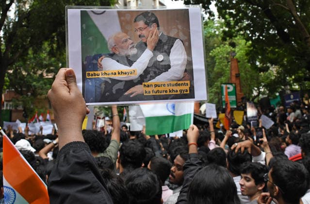 July 24, 2026, Mumbai, Maharashtra, India: A demonstrator (L) holds a placard of Indian Prime Minister Narendra Modi and Union Education Minister Dharmendra Pradhan during a protest in Mumbai. Youths supporting Cockroach Janata Party (CJP) held a protest against alleged paper leaks and irregularities in major national medical entrance examinations, seeking resignation of Union Education Minister Dharmendra Pradhan, demanding greater accountability and reforms in India s education system. Mumbai India - ZUMAs197 20260724_aaa_s197_104 Copyright: xAshishxVaishnavx