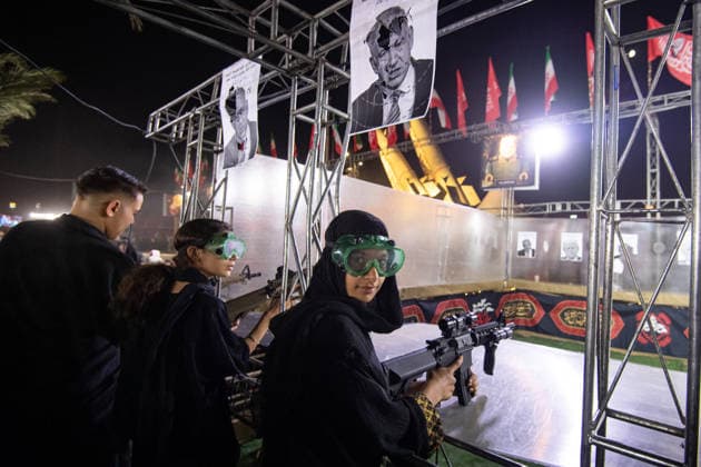 Demonstrators shoot at photos of US President Donald Trump and Israeli Prime Minister Benjamin Netanyahu with pellet guns during a pro‘government protest in Tehran, Iran on Friday, July 24, 2026. U.S. and Iran traded attacks for the 13th night in a row with few signs of either side returning to negociations.  IRN2026072412 BehnamxTofighi