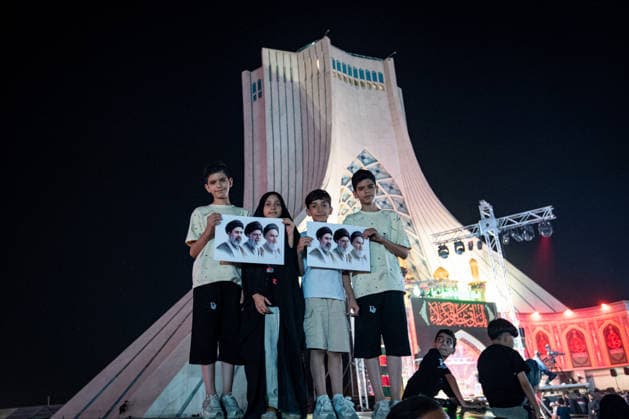 Protesters display images of Iran s Supreme Leader, Ayatollah Ali Khamenei and his successor Ayatollah Mojtaba Khamenei, during a pro-government demonstration in Tehran, Iran, on Friday, July 24, 2026. U.S. and Iran traded attacks for the 13th night in a row with few signs of either side returning to negotiations.  IRN2026072427 BehnamxTofighi