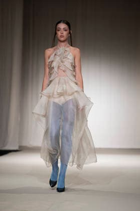 ROMANIAN DESIGNERS - MOMAD Fashion Week de Madrid ,Spain - 24 Jul 2026 A model walks the runway wearing a design by Romanian designers during Momad Fashion Week de Madrid in IFEMA Madrid Spain Copyright: xAtilanoxGarciax xSOPAxImagesx photo03130
