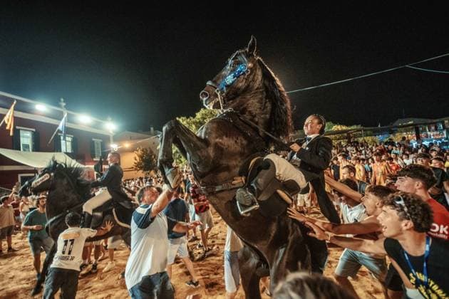July 24, 2026, Es Castell, Menorca Balearic Islands, Spain: A caixer, or horse rider, rears his horse amid a cheering crowd during the traditional Jaleo at the Sant MartoÂ­ Festival in Es Castell. Es Castell Spain  - ZUMAo105 20260724_fap_o105_029 Copyright: xMatthiasxOesterlex