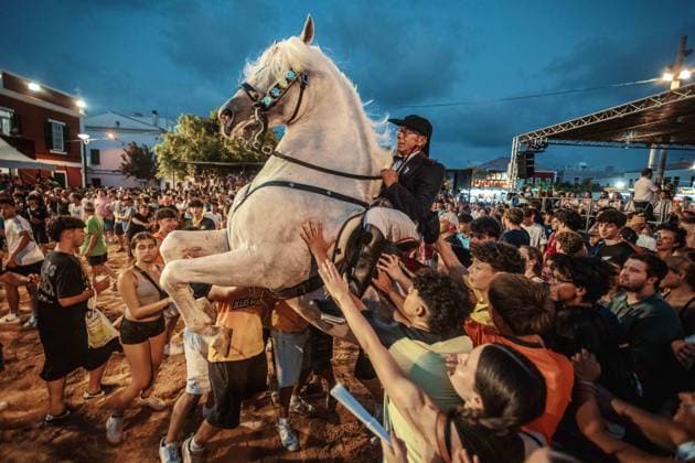 July 24, 2026, Es Castell, Menorca Balearic Islands, Spain: A caixer, or horse rider, rears his horse amid a cheering crowd during the traditional Jaleo at the Sant MartoÂ­ Festival in Es Castell. Es Castell Spain - ZUMAo105 20260724_fap_o105_016 Copyright: xMatthiasxOesterlex