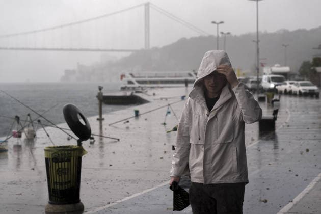Heavy summer rainfall affects parts of Istanbul ISTANBUL, TURKIYE – JULY 25: A pedestrian walks as heavy summer rain falls along the Bosphorus waterfront in Istanbul, Turkiye, on July 25, 2026. Dark clouds covered parts of the city during the rainfall. Arife Karakum Anadolu Istanbul Turkey. Editorial use only. Please get in touch for any other usage.  Copyright: x2026xAnadoluxArifexKarakumx