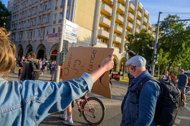 July 24, 2026, Berlin, Berlin, Germany: A person triew to block a journalist film with their placard, at Dyke* March 2026, on July 24 2026, in Berlin, Germany. Thousands of demonstrators marched in the streets of Berlin s City Center and Kreuzberg districts for the annual Dyke* March just a day before the annual CSD parade and Internationalist Queer Pride Berlin Germany  - ZUMAk201 20260724_zip_k201_003 Copyright: xNikosxKanistrasx