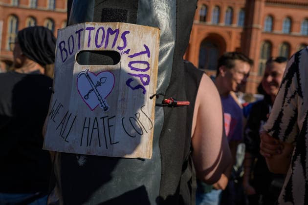 July 24, 2026, Berlin, Berlin, Germany: A person mounts a placard against police on their backpack at Dyke* March 2026, on July 24 2026, in Berlin, Germany. Thousands of demonstrators marched in the streets of Berlin s City Center and Kreuzberg districts for the annual Dyke* March just a day before the annual CSD parade and Internationalist Queer Pride Berlin Germany - ZUMAk201 20260724_zip_k201_002 Copyright: xNikosxKanistrasx