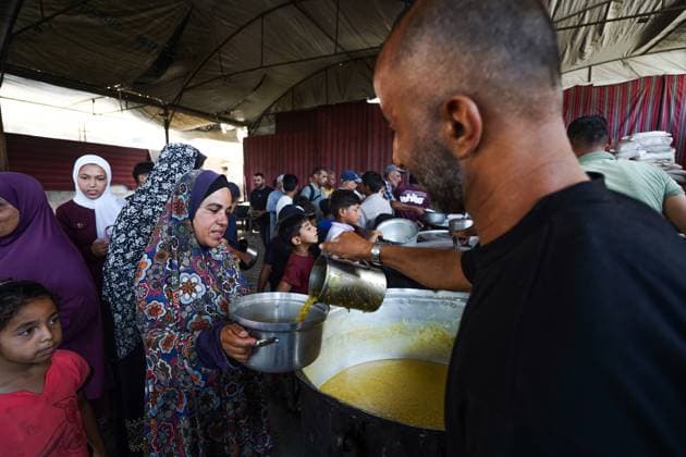 July 25, 2026, Al-Nuseirat Camp, Palestine, State of: AL-NUSEIRAT CAMP, GAZA STRIP Ã¢â‚¬ JULY 25, 2026: A charity kitchen in al-Nuseirat continues to distribute hot meals to displaced Palestinians, amid a severe hunger crisis driven by ongoing restrictions on humanitarian aid entry and a sharp decline in international funding for charity kitchens. Thousands of displaced familiesoÅ’ including children, women, and the elderlyoÅ’ rely on these kitchens as their near-sole source of daily meals, as UN agencies warn of worsening famine conditions across the Strip. Al-Nuseirat Camp Palestine, State of - ZUMAq101 20260725_zna_q101_001 Copyright: xRamzixAbuxAmerx