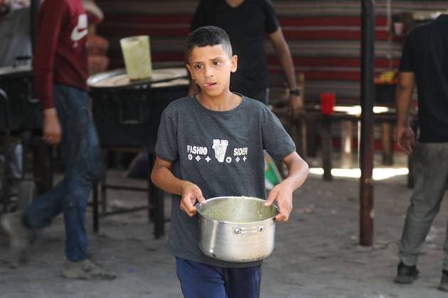 July 26, 2026, Al-Nuseirat Camp, Palestine, State of: AL-NUSEIRAT CAMP, GAZA STRIP Ã¢â‚¬ JULY 25, 2026: A charity kitchen in al-Nuseirat continues to distribute hot meals to displaced Palestinians, amid a severe hunger crisis driven by ongoing restrictions on humanitarian aid entry and a sharp decline in international funding for charity kitchens. Thousands of displaced familiesoÅ’ including children, women, and the elderlyoÅ’ rely on these kitchens as their near-sole source of daily meals, as UN agencies warn of worsening famine conditions across the Strip. Al-Nuseirat Camp Palestine, State of - ZUMAq101 20260726_zna_q101_016 Copyright: xRamzixAbuxAmerx