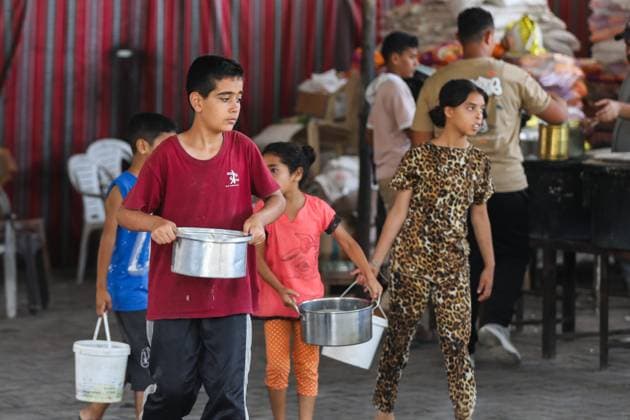 July 26, 2026, Al-Nuseirat Camp, Palestine, State of: AL-NUSEIRAT CAMP, GAZA STRIP Ã¢â‚¬ JULY 25, 2026: A charity kitchen in al-Nuseirat continues to distribute hot meals to displaced Palestinians, amid a severe hunger crisis driven by ongoing restrictions on humanitarian aid entry and a sharp decline in international funding for charity kitchens. Thousands of displaced familiesoÅ’ including children, women, and the elderlyoÅ’ rely on these kitchens as their near-sole source of daily meals, as UN agencies warn of worsening famine conditions across the Strip. Al-Nuseirat Camp Palestine, State of - ZUMAq101 20260726_zna_q101_012 Copyright: xRamzixAbuxAmerx