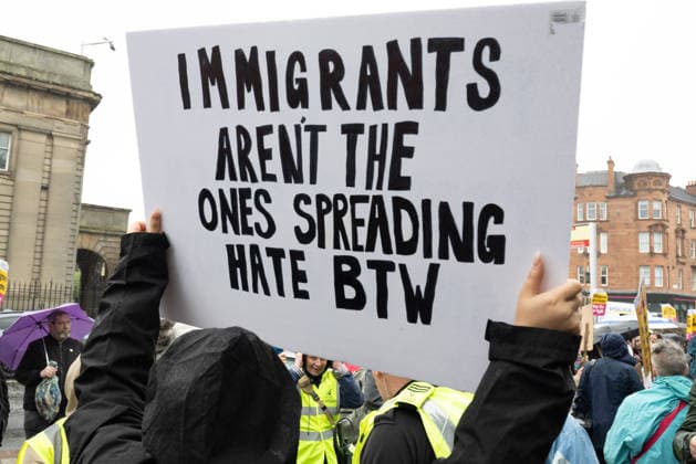 July 25, 2026, Glasgow, Scotland, UK: Pro-immigration protesters aligned with Stand Up To Racism Scotland and other allied organisations hold placards and banners during a demonstration in Glasgow. The protest took place amid heightened tensions over immigration and asylum seekers following months of unrest and protests across Scotland and was met with a counter protest held by anti-immigration supporters. Glasgow UK - ZUMAs357 20260725_zip_s357_001 Copyright: xCameronxScottx