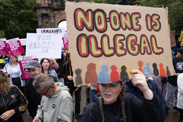 July 25, 2026, Glasgow, Scotland, UK: Pro-immigration protesters aligned with Stand Up To Racism Scotland and other allied organisations hold placards and banners during a demonstration in Glasgow. The protest took place amid heightened tensions over immigration and asylum seekers following months of unrest and protests across Scotland and was met with a counter protest held by anti-immigration supporters. Glasgow UK - ZUMAs357 20260725_zip_s357_006 Copyright: xCameronxScottx