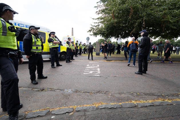 July 25, 2026, Glasgow, Scotland, UK: Police officers contain rival groups of pro- and anti-immigration protesters during a demonstration in Glasgow amid heightened tensions over immigration and asylum seekers. Protesters aligned with Unite The Clans Scotland, which describes itself as a patriotic group, were met by a counter-demonstration led by Stand Up To Racism Scotland and other allied organisations. Glasgow UK  - ZUMAs357 20260725_zip_s357_011 Copyright: xCameronxScottx
