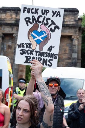 July 25, 2026, Glasgow, Scotland, UK: Pro-immigration protesters aligned with Stand Up To Racism Scotland and other allied organisations hold placards and banners during a demonstration in Glasgow. The protest took place amid heightened tensions over immigration and asylum seekers following months of unrest and protests across Scotland and was met with a counter protest held by anti-immigration supporters. Glasgow UK  - ZUMAs357 20260725_zip_s357_014 Copyright: xCameronxScottx