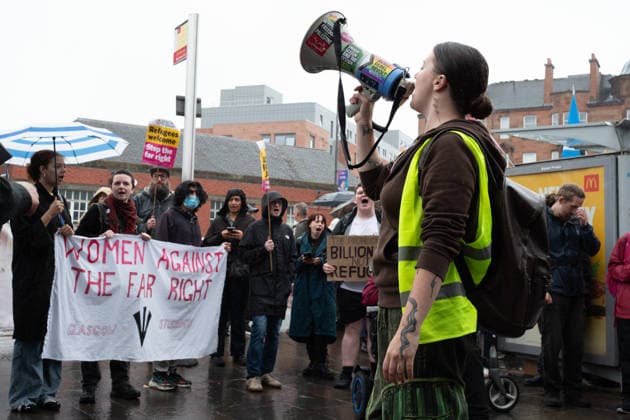 July 25, 2026, Glasgow, Scotland, UK: Pro-immigration protesters aligned with Stand Up To Racism Scotland and other allied organisations hold placards and banners during a demonstration in Glasgow. The protest took place amid heightened tensions over immigration and asylum seekers following months of unrest and protests across Scotland and was met with a counter protest held by anti-immigration supporters. Glasgow UK - ZUMAs357 20260725_zip_s357_012 Copyright: xCameronxScottx