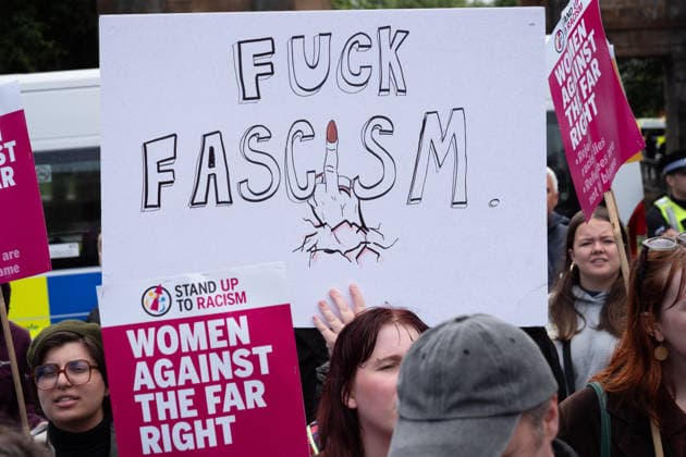 July 25, 2026, Glasgow, Scotland, UK: Pro-immigration protesters aligned with Stand Up To Racism Scotland and other allied organisations hold placards and banners during a demonstration in Glasgow. The protest took place amid heightened tensions over immigration and asylum seekers following months of unrest and protests across Scotland and was met with a counter protest held by anti-immigration supporters. Glasgow UK - ZUMAs357 20260725_zip_s357_013 Copyright: xCameronxScottx