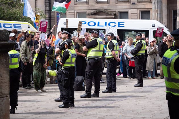 July 25, 2026, Glasgow, Scotland, UK: Police officers contain rival groups of pro- and anti-immigration protesters during a demonstration in Glasgow amid heightened tensions over immigration and asylum seekers. Protesters aligned with Unite The Clans Scotland, which describes itself as a patriotic group, were met by a counter-demonstration led by Stand Up To Racism Scotland and other allied organisations. Glasgow UK - ZUMAs357 20260725_zip_s357_017 Copyright: xCameronxScottx