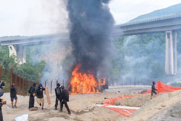 July 25, 2026, Chiomonte, Val Di Susa, Italy: CHIOMONTE, VAL DI SUSA, PIEDMONT, ITALY Ã¢â‚¬ JULY 25, 2026: Masked activists from the No TAV movement, a protest movement opposing the Turin-Lyon high-speed railway project, clash with security forces in Chiomonte, Val di Susa, Piedmont, Italy, after storming the high-speed rail construction site. Protesters threw rocks and firecrackers, setting fire to four vehicles belonging to the Carabinieri and Guardia di Finanza. Police responded with tear gas and water cannons, leaving more than 50 security personnel injured and forcing the closure of a section of the A32 Turin-Bardonecchia motorway. Chiomonte, Val Di Susa Italy  - ZUMAq101 20260725_zna_q101_167 Copyright: xLeonardoxGaravagliax