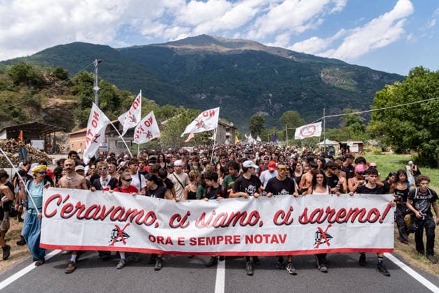 July 25, 2026, Susa, Piedmont, Italy: On July 25, 2026, thousands of people departed from AltaFelicito , a music festival in Venaus, to reach the construction sites of the TAV (High speed rail), a railway project to connect Italy and France. The demonstrators managed to enter the site and there clashed with the police, who responded with tear gas. Many of the buildings inside were put on fire, including two police vehicles. The TAV project has been highly contested during the last 30 years because of environmental damages and increasing costs. Susa Italy  - ZUMAs377 20260725_znp_s377_014 Copyright: xPietroxStariccox
