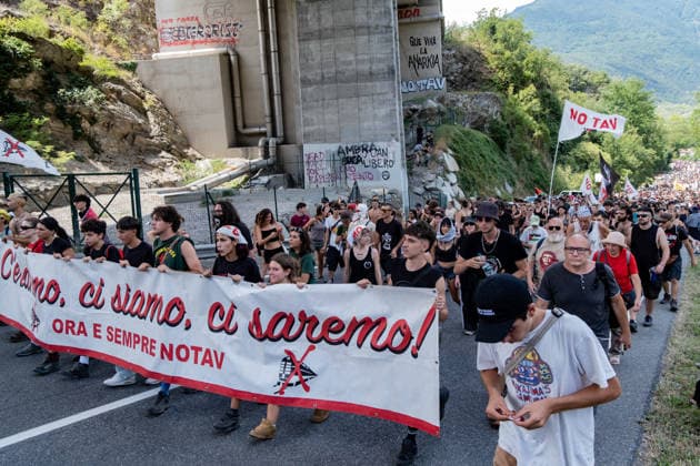 July 25, 2026, Susa, Piedmont, Italy: On July 25, 2026, thousands of people departed from AltaFelicito , a music festival in Venaus, to reach the construction sites of the TAV (High speed rail), a railway project to connect Italy and France. The demonstrators managed to enter the site and there clashed with the police, who responded with tear gas. Many of the buildings inside were put on fire, including two police vehicles. The TAV project has been highly contested during the last 30 years because of environmental damages and increasing costs. Susa Italy  - ZUMAs377 20260725_znp_s377_018 Copyright: xPietroxStariccox