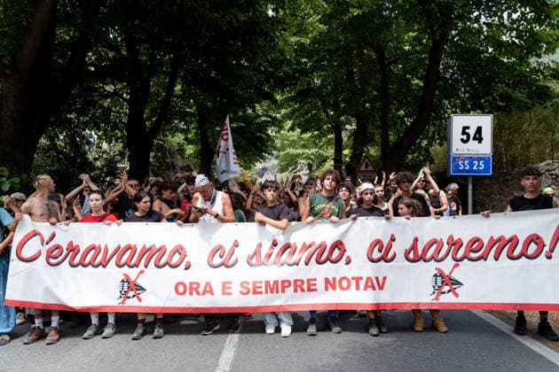 July 25, 2026, Susa, Piedmont, Italy: On July 25, 2026, thousands of people departed from AltaFelicito , a music festival in Venaus, to reach the construction sites of the TAV (High speed rail), a railway project to connect Italy and France. The demonstrators managed to enter the site and there clashed with the police, who responded with tear gas. Many of the buildings inside were put on fire, including two police vehicles. The TAV project has been highly contested during the last 30 years because of environmental damages and increasing costs. Susa Italy  - ZUMAs377 20260725_znp_s377_021 Copyright: xPietroxStariccox