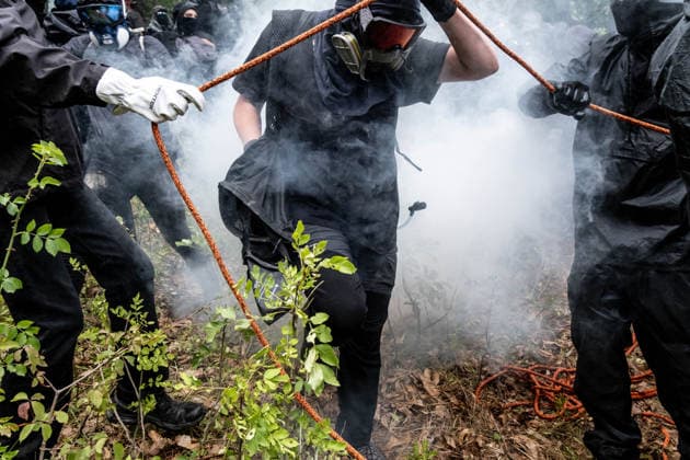 July 25, 2026, Susa, Piedmont, Italy: On July 25, 2026, thousands of people departed from AltaFelicito , a music festival in Venaus, to reach the construction sites of the TAV (High speed rail), a railway project to connect Italy and France. The demonstrators managed to enter the site and there clashed with the police, who responded with tear gas. Many of the buildings inside were put on fire, including two police vehicles. The TAV project has been highly contested during the last 30 years because of environmental damages and increasing costs. Susa Italy  - ZUMAs377 20260725_znp_s377_028 Copyright: xPietroxStariccox