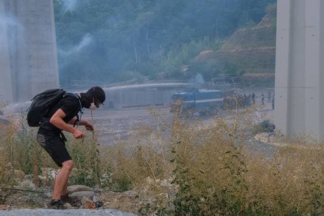 July 25, 2026, Chiomonte, Val Di Susa, Italy: CHIOMONTE, VAL DI SUSA, PIEDMONT, ITALY Ã¢â‚¬ JULY 25, 2026: Masked activists from the No TAV movement, which opposes the Turin-Lyon high-speed railway project, clash with security forces after storming the high-speed rail construction site in Chiomonte. Protesters threw rocks and firecrackers, setting fire to four vehicles belonging to the Carabinieri and Guardia di Finanza. Police responded with tear gas and water cannons, leaving more than 50 security personnel injured and forcing the closure of a section of the A32 Turin-Bardonecchia motorway. Chiomonte, Val Di Susa Italy  - ZUMAq101 20260725_zna_q101_274 Copyright: xLeonardoxGaravagliax