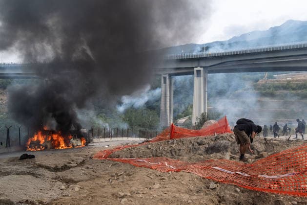 July 25, 2026, Susa, Piedmont, Italy: On July 25, 2026, thousands of people departed from AltaFelicito , a music festival in Venaus, to reach the construction sites of the TAV (High speed rail), a railway project to connect Italy and France. The demonstrators managed to enter the site and there clashed with the police, who responded with tear gas. Many of the buildings inside were put on fire, including two police vehicles. The TAV project has been highly contested during the last 30 years because of environmental damages and increasing costs. Susa Italy  - ZUMAs377 20260725_znp_s377_040 Copyright: xPietroxStariccox