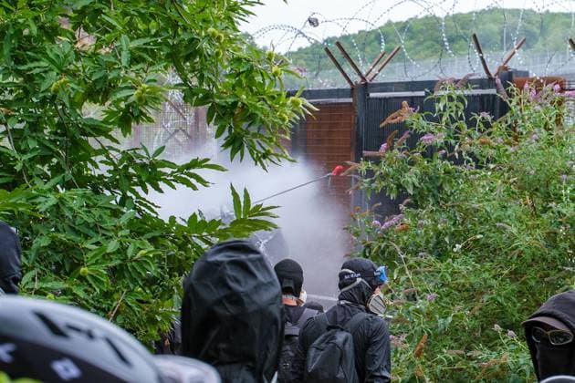 July 25, 2026, Chiomonte, Val Di Susa, Italy: CHIOMONTE, VAL DI SUSA, PIEDMONT, ITALY Ã¢â‚¬ JULY 25, 2026: Masked activists from the No TAV movement, which opposes the Turin-Lyon high-speed railway project, clash with security forces after storming the high-speed rail construction site in Chiomonte. Protesters threw rocks and firecrackers, setting fire to four vehicles belonging to the Carabinieri and Guardia di Finanza. Police responded with tear gas and water cannons, leaving more than 50 security personnel injured and forcing the closure of a section of the A32 Turin-Bardonecchia motorway. Chiomonte, Val Di Susa Italy  - ZUMAq101 20260725_zna_q101_287 Copyright: xLeonardoxGaravagliax
