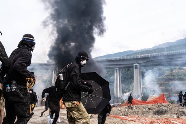July 25, 2026, Susa, Piedmont, Italy: Smoke rises from burning buildings and vehicles inside the Turin Lyon high-speed rail (TAV) construction site during a protest near Venaus. Thousands of demonstrators marched from the Alta FelicitÃ music festival to the construction site, where some protesters breached the perimeter and clashes broke out with police, who used tear gas. Several structures and vehicles inside the site were set on fire. The Turin Lyon high-speed rail project has faced opposition for decades over its environmental impact and cost. Susa Italy  - ZUMAs377 20260725_znp_s377_034 Copyright: xPietroxStariccox