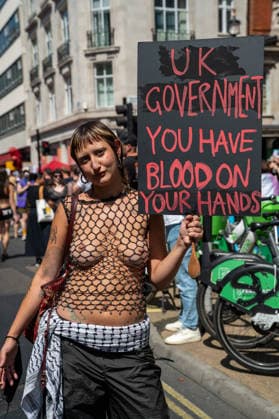 July 25, 2026, London, Westminster, United Kingdom: (EDITOR S NOTE; Images contains nudity).An activist holds a placard during the Trans+ Pride London march. Thousands of people joined the seventh annual Trans+ Pride march and rally in central London. The event celebrated the trans community while promoting equality and challenging discrimination through visibility and collective action. The march set off from Langham Place at 2 p.m., paused at three points for speeches and to welcome additional participants, and concluded with a rally and further speeches in Trafalgar Square. London United Kingdom - ZUMAs197 20260725_aaa_s197_287 Copyright: xJamesxWilloughbyx