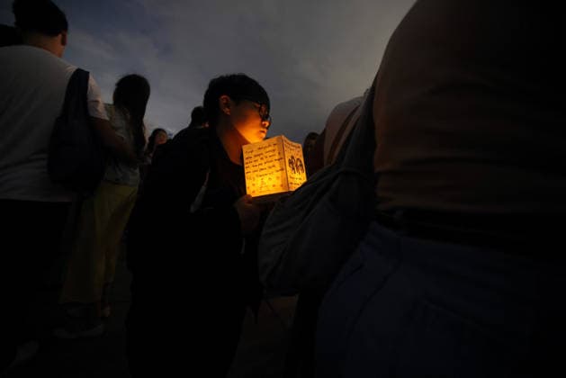 July 25, 2026, Rio De Janeiro, Rio De Janeiro, Brazil: Hundreds came to the inaugural Water Lantern Festival at the Museum of Tomorrow (Museu do AmanhoÂ£) in Rio de Janeiro, Brazil to release illuminated water lanterns fitted with small LED lights. Participants personalized the floating lanterns with messages before setting them on the water at sunset, creating a display intended to symbolize hope, healing, remembrance and unity. The festival, which is held annually in dozens of cities around the world, including New York, Los Angeles, Toronto, London and Sydney, made its Brazil debut in Rio de Janeiro. Rio De Janeiro Brazil - ZUMAk251 20260725_znp_k251_006 Copyright: xBobxKarpx