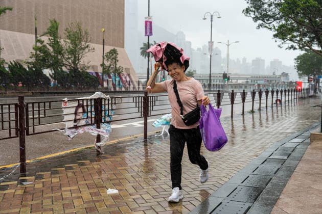 HONGKONG-TYPHOON NOUL A woman reacts to the wind during typhoon Noul in Hong Kong, July 26, 2026. NEXPHER Vernon Yuen HONG KONG