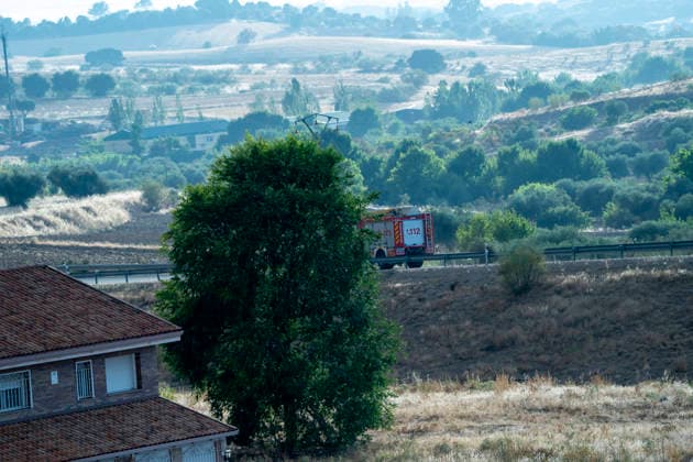 A fire truck drives along a road in the Madrid region heading toward the area affected by the Sierra Oeste wildfire which keeps hundreds of firefighting personnel deployed in the region. July 25, 2026. (202607251315)