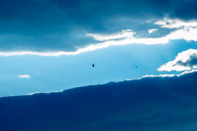 A firefighting helicopter flies over the area affected by the Sierra Oeste wildfire in the Madrid region dropping water on the fire front that forced the evacuation of thousands of people in the region. July 25, 2026. (202607251320)