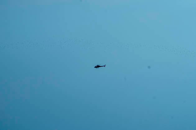 A firefighting helicopter flies over the area affected by the Sierra Oeste wildfire in the Madrid region dropping water on the fire front that forced the evacuation of thousands of people in the region. July 25, 2026. (202607251318)