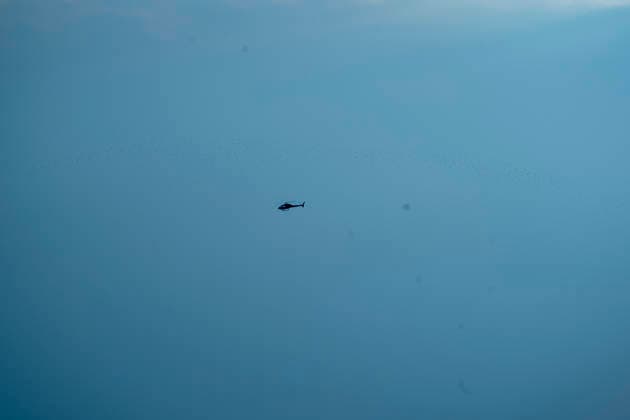 A firefighting helicopter flies over the area affected by the Sierra Oeste wildfire in the Madrid region dropping water on the fire front that forced the evacuation of thousands of people in the region. July 25, 2026. (202607251319)