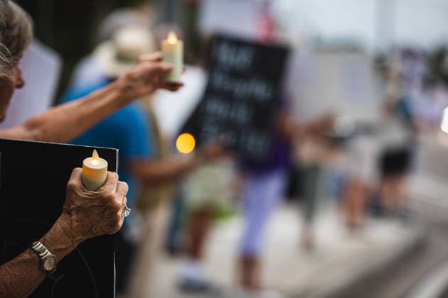 July 25, 2026, Naples, Florida, USA: Protestors hold signs in protest of the IMMIGRATION AND CUSTOMS ENFORCEMENT (ICE) tactics and treatment of community members. Naples USA - ZUMAd256 20260725_znp_d256_048 Copyright: xDavexDeckerx