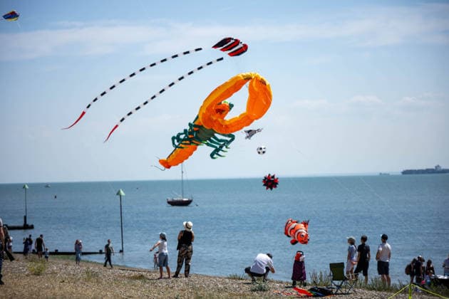 July 25, 2026, Essex, United Kingdom: A giant orange lobster kite flies above the sea during the Kite Festival at Southend-On-Sea, alongside a red parafoil with long striped tails, a clownfish and a football kite, as spectators watch from the beach below. The Kite Festival Southend s Alternative Airshow, organised by Project Southchurch, was held on the Eastern Esplanade at Thorpe Bay seafront, Southend-On-Sea, Essex. Essex United Kingdom - ZUMAs197 20260725_aaa_s197_420 Copyright: xIanxDavidsonx