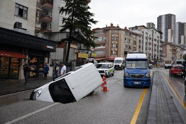 Heavy rainfall causes flooding, road collapse in Ankara ANKARA, TURKIYE - JULY 25: A car is seen trapped in a sinkhole after the road collapsed following heavy rainfall in Ankara, Turkiye, on July 25, 2026. Intense morning downpours caused sections of the road to give way, leaving the vehicle partially submerged. Muhammed Abdullah Kurtar Anadolu Ankara Turkey. Editorial use only. Please get in touch for any other usage.  Copyright: x2026xAnadoluxMuhammedxAbdullahxKurtarx