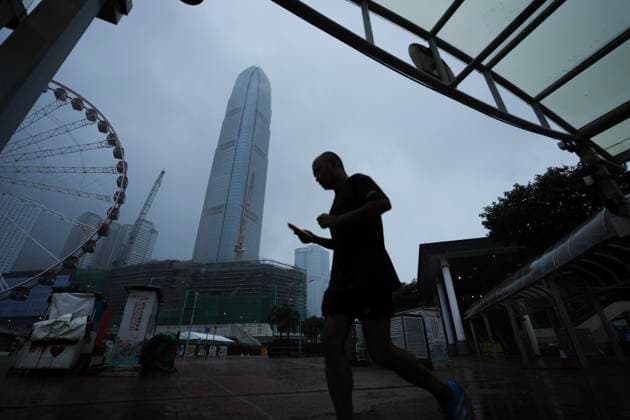 (260726) -- HONG KONG, July 26, 2026 -- A man walks on a street in Hong Kong, south China, July 26, 2026. The Hong Kong Observatory issued the No. 8 Northwest Gale or Storm Signal on Saturday night under the effect of super typhoon Noul. The No. 8 signal is the third-highest warning under Hong Kong s weather system, which has five rankings for typhoons. (Photo by Xinhua) CHINA-HONG KONG-NO. 8 TYPHOON SIGNAL (CN) LuixSiuxWai 