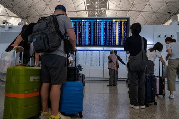 HONGKONG-TYPHOON NOUL Travelers looking at a flight information display board inside Terminal 1 at Hong Kong International Airpot during typhoon Noul in Hong Kong, July 26, 2026. NEXPHER Vernon Yuen HONG KONG