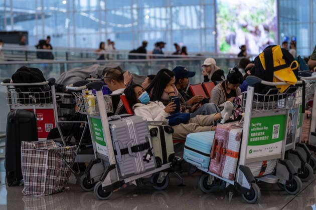 HONGKONG-TYPHOON NOUL Travelers sitting on chairs inside terminal 1 at Hong Kong International Airpot during typhoon Noul in Hong Kong, July 26, 2026. NEXPHER Vernon Yuen HONG KONG