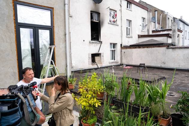 A resident talks to the press outside a residential building at the Haachtsesteenweg chaussee de Haecht in Schaarbeek Schaerbeek, Brussels, after last night s fire, Sunday 26 July 2026. Two people died in the fire Eight others were injured. Two of them are in serious condition. The cause of the fire is still under investigation. MARIUS BURGELMAN  MariusxBurgelman 182073298