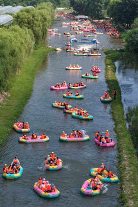 (260726) -- SHIJIAZHUANG, July 26, 2026 -- An aerial drone photo taken on July 26, 2026 shows tourists enjoying rafting at the grand canyon rafting scenic area in Pingshan County of Shijiazhuang, north China s Hebei Province. Shijiazhuang City has leveraged the high-quality mountain and water resources of the Taihang Mountains to develop distinctive cultural tourism experience programs in recent years, attracting a large influx of tourists for summer retreats. (Photo by Xinhua) CHINA-HEBEI-SHIJIAZHUANG-TAIHANG MOUNTAINS-COOLING ECONOMY (CN) YanxZhiguo 