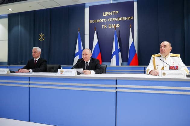 RUSSIA, ST PETERSBURG - JULY 26, 2026: Russian Navy Commander-in-Chief Admiral Alexander Moiseyev, Russia s President Vladimir Putin, and Defence Minister Andrei Belousov (R-L) meet with senior officers of the Russian Navy at the Admiralty Building on Russian Navy Day. Vyacheslav Prokofyev Russian Presidential Press and Information Office TASS  95487722