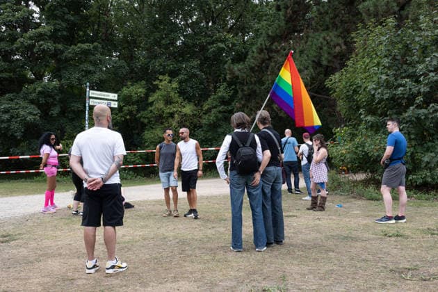 July 26, 2026, Berlin, Germany: A group of people stands behind police barriers near the site of the car attack in Tiergarten park, close to the route of the CSD Pride parade. On the evening of July 25, a car drove into people, killing one person and injuring 16 others. The attack brought Berlin™s annual Pride celebrations to an early end. Police are investigating and searching for the suspected driver. A vehicle drove into a crowd near Berlin s annual Christopher Street Day (CSD) Pride celebrations in Tiergarten on the evening of 25 July, killing one person and injuring 29 others, several of them seriously. The incident prompted the cancellation of one of Europe s largest Pride events as emergency services responded to the scene. German  - ZUMAs197 20260726_aaa_s197_013 Copyright: xVasilyxKrestyaninovx