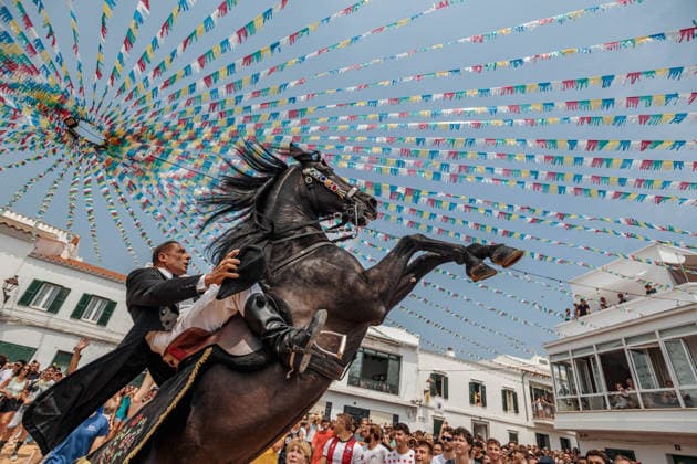 July 26, 2026, Fornells, Menorca Balearic Islands, Spain: A caixer, or horse rider, rears his horse amid a cheering crowd during the traditional Jaleo at the Sant Antoni Festival in Fornells. Fornells Spain  - ZUMAo105 20260726_fap_o105_003 Copyright: xMatthiasxOesterlex