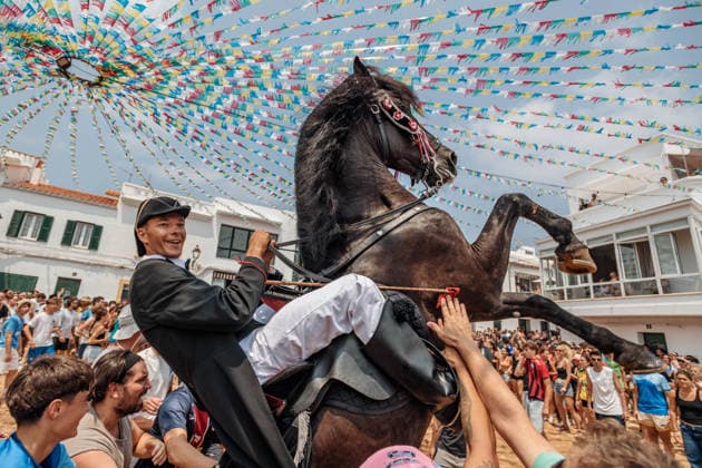 July 26, 2026, Fornells, Menorca Balearic Islands, Spain: A caixer, or horse rider, rears his horse amid a cheering crowd during the traditional Jaleo at the Sant Antoni Festival in Fornells. Fornells Spain  - ZUMAo105 20260726_fap_o105_004 Copyright: xMatthiasxOesterlex